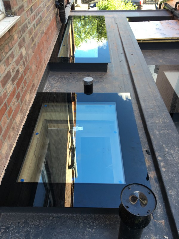 Multiple flat roof skylights on extension in East Molesey