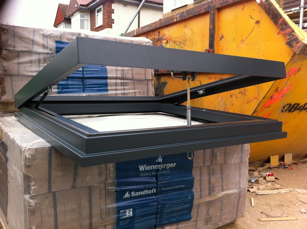 Opening flat roof skylight in anthracite grey installed in East Molesey