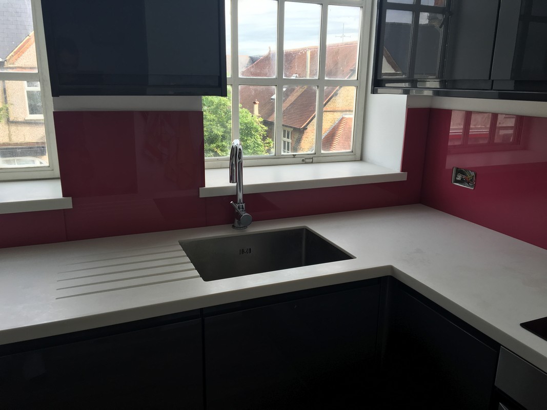 Deep plum coloured glass splashback in modern East Molesey kitchen