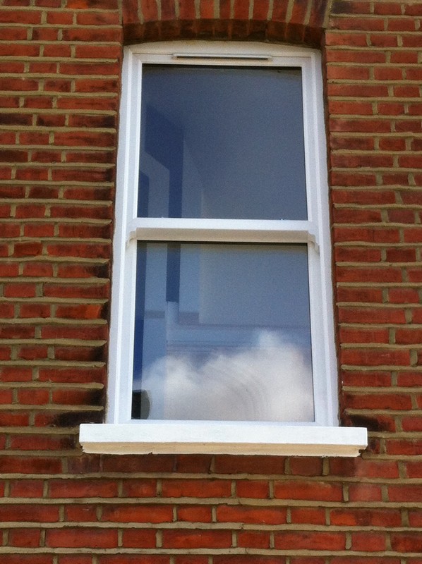 uPVC sash window on Victorian red brick house in East Molesey